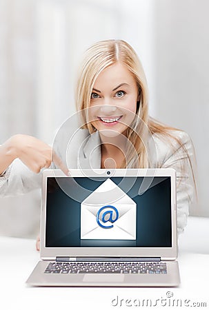 Woman with laptop pointing at email sign Stock Photo