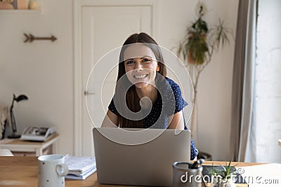 Woman lean at table with laptop smile staring at camera Stock Photo