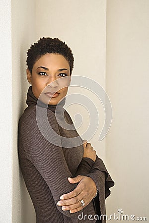 Woman leaning against wall. Stock Photo