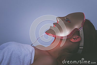 Woman with led light therapy facial beauty mask photon therapy Stock Photo