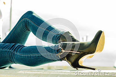 Woman legs in denim pants heels shoes outdoor Stock Photo