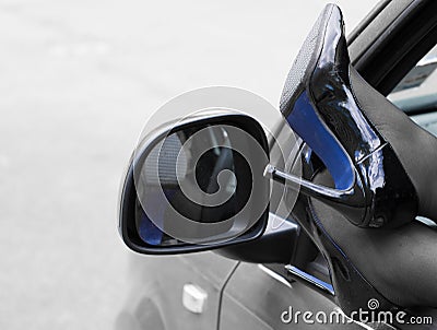 Woman legs in high heels out the window of car Stock Photo