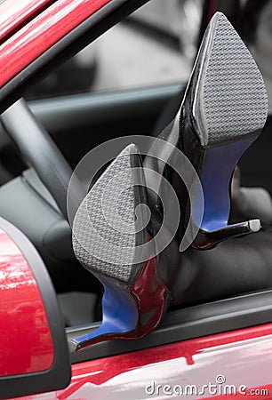 Woman legs in high heels out the window of car Stock Photo