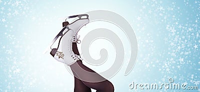 Woman legs in ice skating boots legs-up position on the blue snowy background Stock Photo