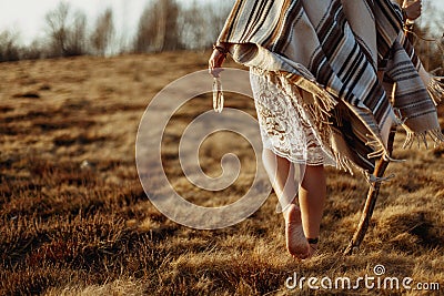 Woman legs in native indian american boho dress walking in windy Stock Photo