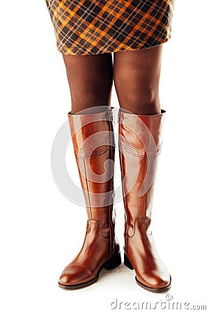 Woman legs wearing brown leather high boots Stock Photo