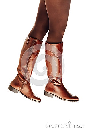 Woman legs wearing brown leather high boots Stock Photo