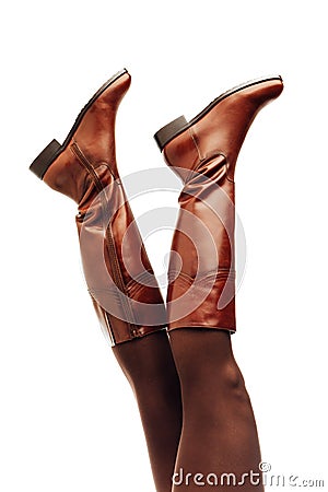 Woman legs wearing brown leather high boots upside down Stock Photo