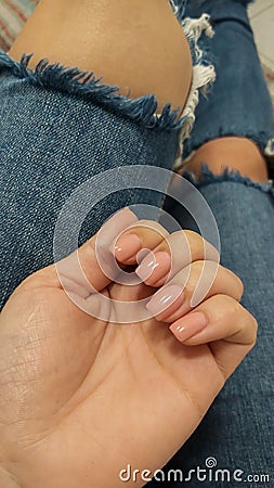 woman legs wearing ripped jeans close up. girl wearing torn jeans close up Stock Photo