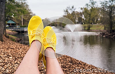 Woman legs in wearing sneakers yellow Stock Photo