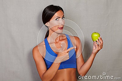 Woman licking his lips and pointing to apple Stock Photo