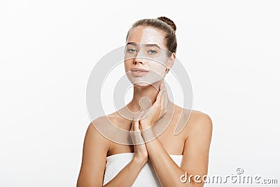 Woman with lifting cream applied on a half of her face, isolated on white Stock Photo