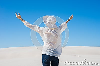 Woman lifting her hands up in the air Stock Photo