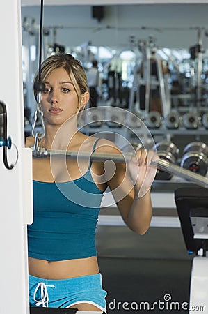 Woman Lifting Weights On A Lat Pull Machine Stock Photo