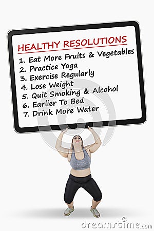 Woman lifts board with healthy resolutions Stock Photo