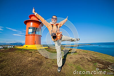 Woman and lighthouse in Iceland Stock Photo