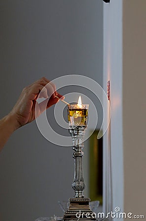 A woman lights Shabbat candles Stock Photo