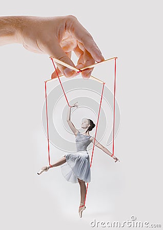 Woman like a puppet in somebodies hands. Concept of manipulation Stock Photo