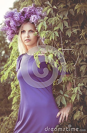 Woman with Lilac flowers Stock Photo