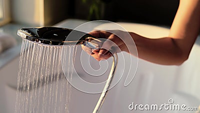 A woman in lingerie fills the tub with water for a relaxing bubble bath. The concept of body care, hygiene and Stock Photo