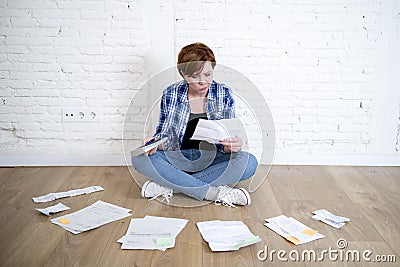 Woman at living room floor with calculator and bank and bills paperwork and documents doing domestic financial accounting Stock Photo