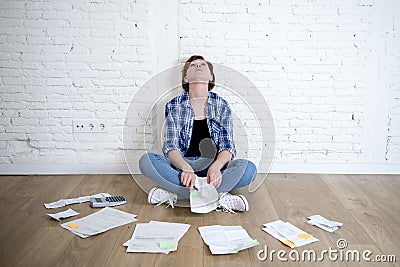 Woman at living room floor with calculator and bank and bills paperwork and documents doing domestic financial accounting Stock Photo