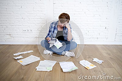 Woman at living room floor with calculator and bank and bills paperwork and documents doing domestic financial accounting Stock Photo