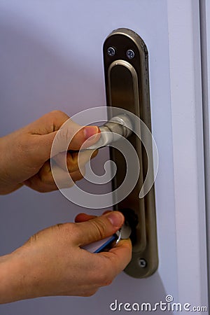 Woman locking the door Stock Photo