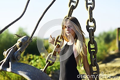 Woman with long hair pose with rusty chains, beauty Stock Photo