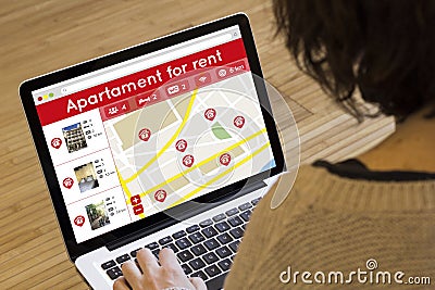 Woman lookin apartment for rent on her laptop Stock Photo