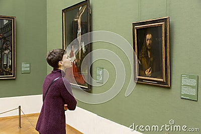 Woman looking at Albrecht Durer self portrait Editorial Stock Photo