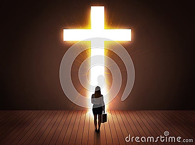 Woman looking at bright cross sign Stock Photo