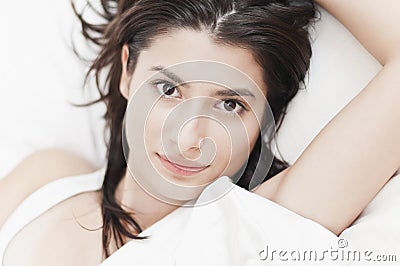 Woman looking at camera and smiling in the morning Stock Photo