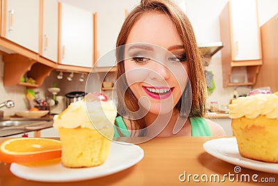 Woman looking at delicious sweet cake. Gluttony. Stock Photo