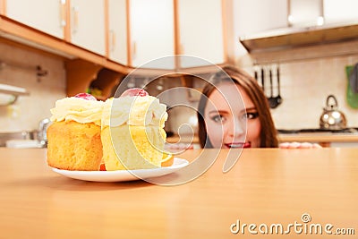 Woman looking at delicious sweet cake. Gluttony. Stock Photo