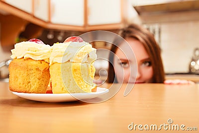 Woman looking at delicious sweet cake. Gluttony. Stock Photo