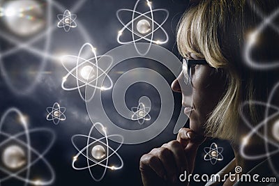 Woman looking explores atoms . Stock Photo