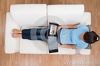 Woman Looking At Family Photo Album Stock Photo