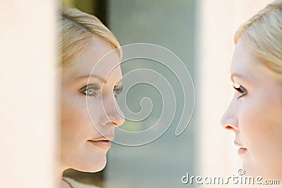 Woman looking at her reflection Stock Photo