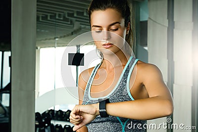 Woman is looking on her smar watches in gym Stock Photo