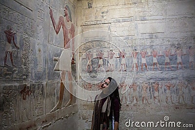 Woman looking at Hieroglyphs in Saqqara necropolis near Cairo in Egypt Editorial Stock Photo