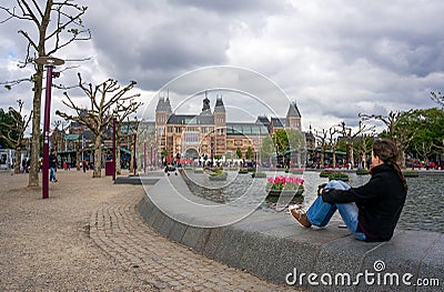 Woman looking at the I amsterdam big letters Editorial Stock Photo