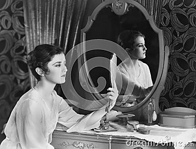 Woman looking in mirror Stock Photo