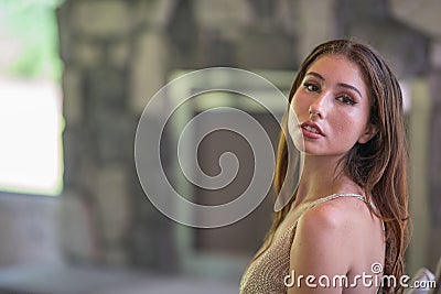 Woman looking over shoulder with head tilted back Stock Photo