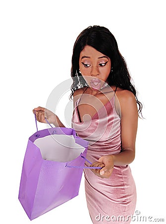 Woman looking surprised in her shopping bag Stock Photo