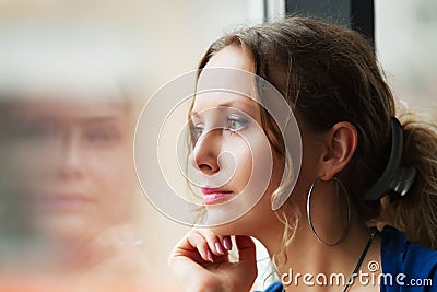 Sad woman looking out window Stock Photo