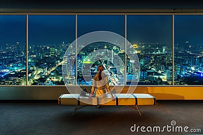 Woman looks at night cityscape Stock Photo