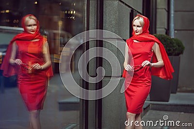 Woman looks at the shop window. Stock Photo