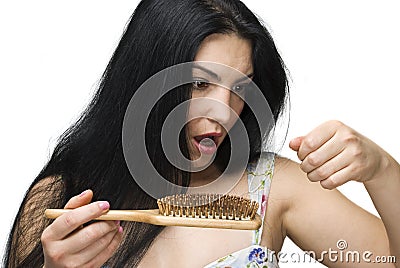 Woman losing hair on hairbrush Stock Photo