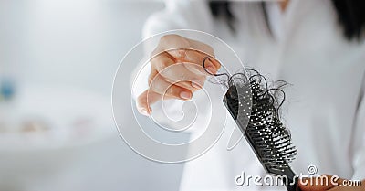 Woman losing hair on hairbrush in hand, soft focus Stock Photo